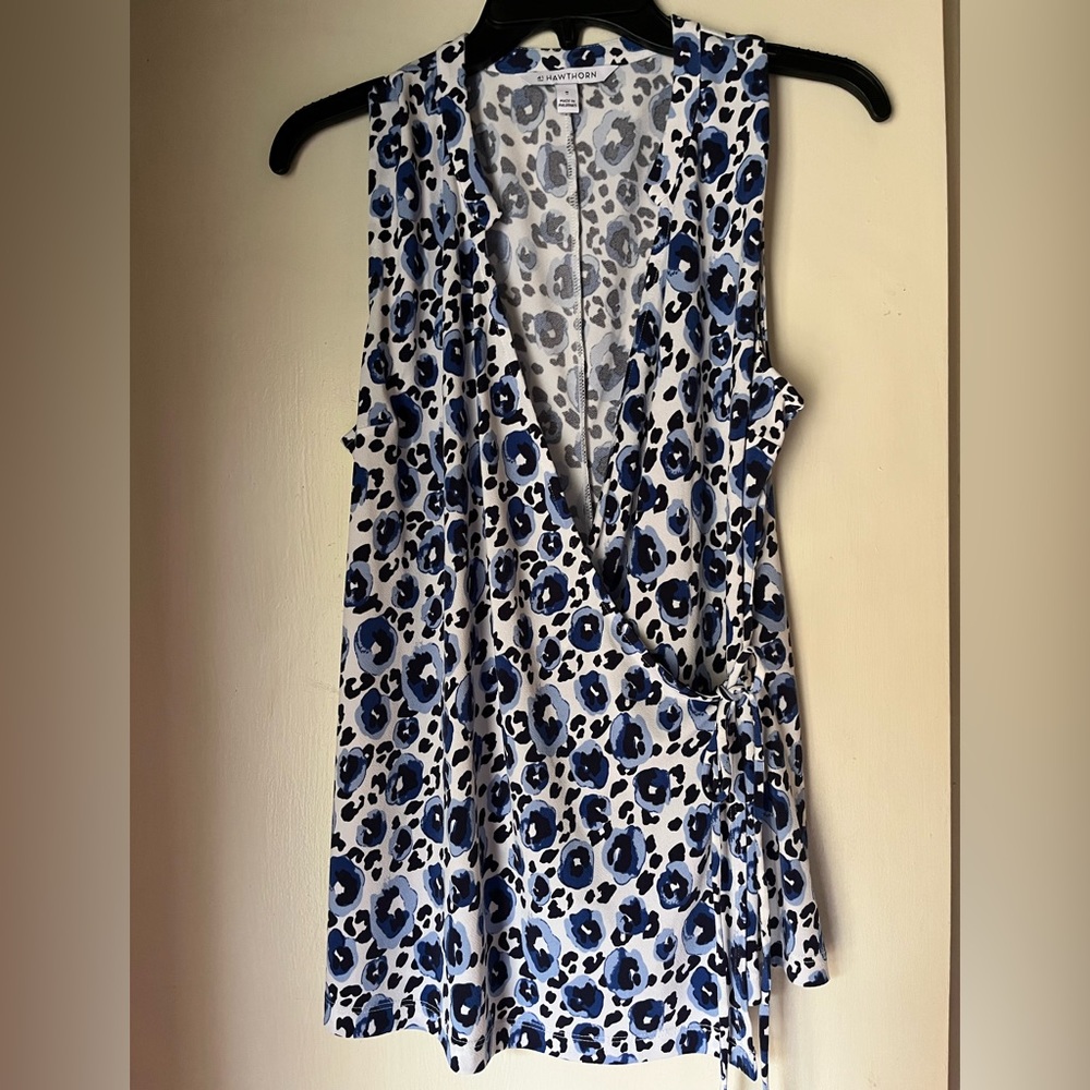 Sleeveless blouse.  95% polyester, 5% spandex. Machine wash